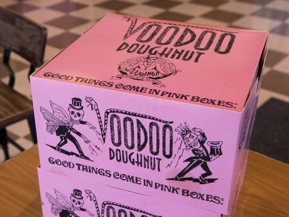 Pink doughnut boxes at Voodoo Doughnut.