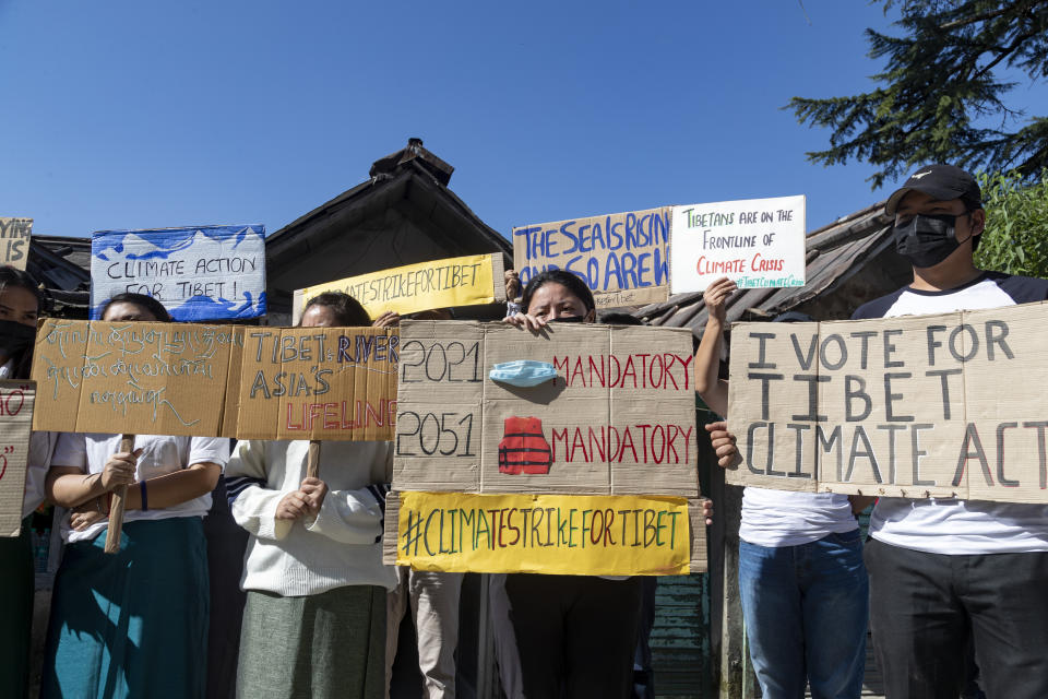 Exile Tibetans participate in a street protest to highlight environmental issues in Tibet ahead of the COP26 summit, in Dharmsala, India, Friday, Oct. 22, 2021. (AP Photo/Ashwini Bhatia)