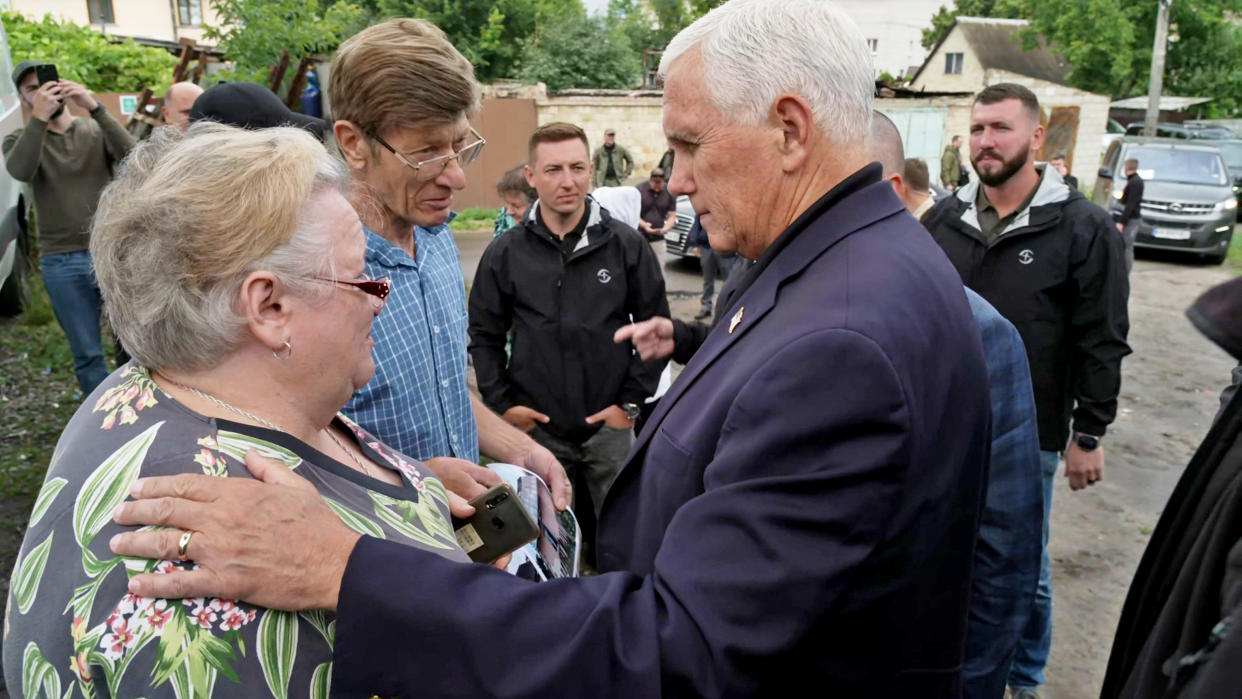 Pence rests his hands on a woman's shoulder as he speaks with her in Irpin, Ukraine (David Gladstone / NBC News)