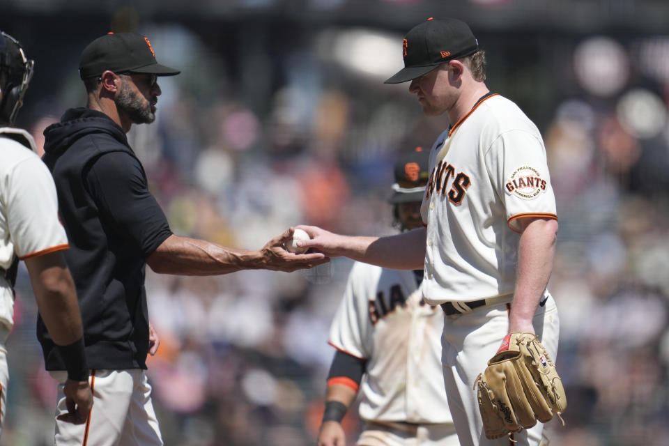 San Francisco Giants manager Gabe Kapler, left, takes the ball from pitcher Logan Webb while making a pitching change during the seventh inning of a baseball game against the St. Louis Cardinals in San Francisco, Thursday, April 27, 2023. (AP Photo/Jeff Chiu)