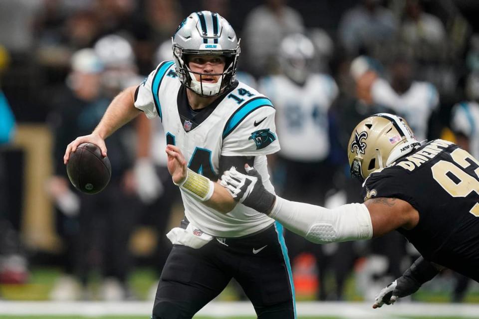 Carolina Panthers quarterback Sam Darnold runs around New Orleans Saints defensive end Marcus Davenport during the first half of an NFL football game between the Carolina Panthers and the New Orleans Saints in New Orleans, Sunday, Jan. 8, 2023. Darnold threw for only 43 yards and had two interceptions, but the Panthers still won, 10-7.