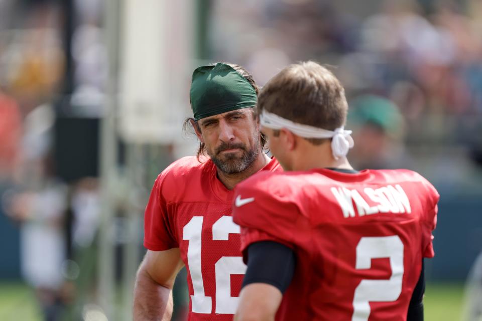 New Jets QB Aaron Rodgers (12) talks with Jets' 2021 No. 2 pick Zach Wilson (2) during a joint NFL football training camp practice in 2021 with the Packers.