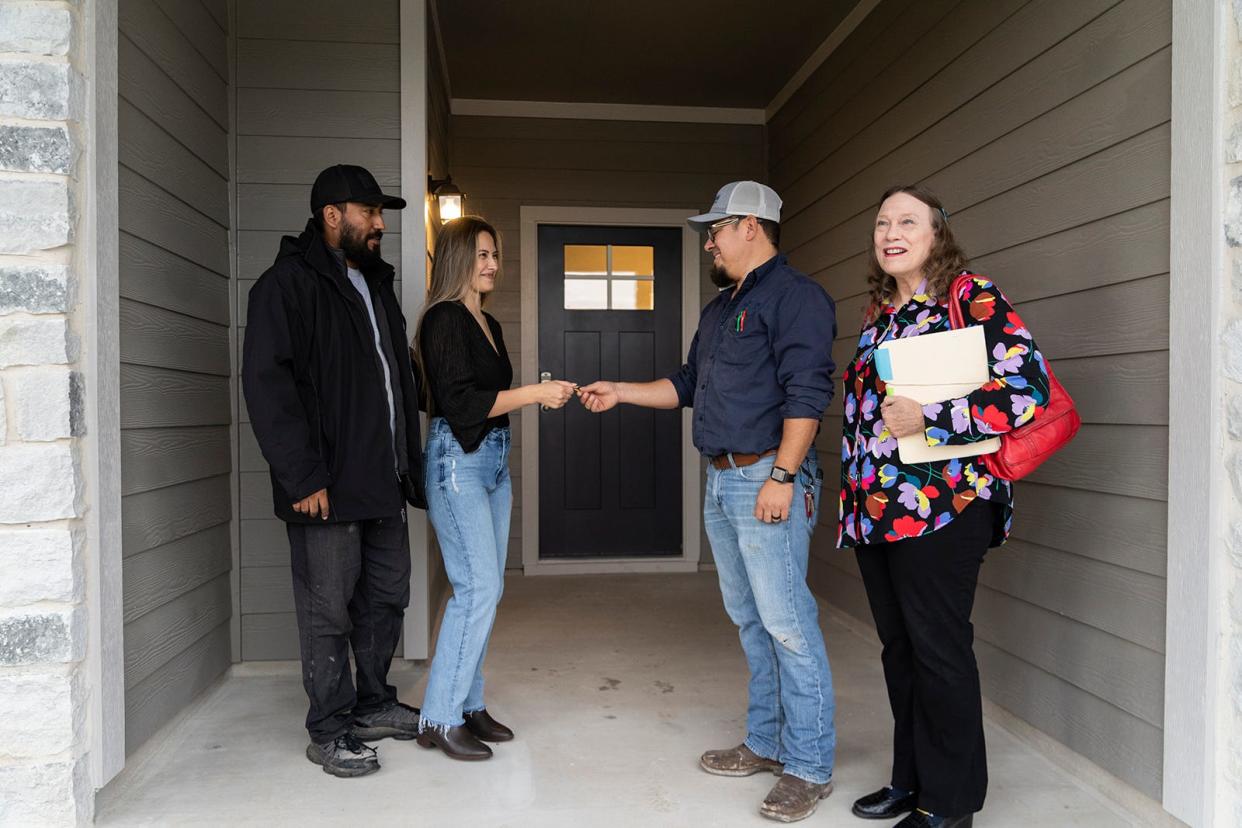 Jose and Nidia Gomez, left, receive the keys to the family's new home in Hutto from Shawn Salazar, D.R. Horton superintendent, alongside JBGoodwin real estate agent Annette Von Ahn, on Nov. 13. The Gomezes were able to take advantage of incentives the homebuilder is offering to purchase their first home.