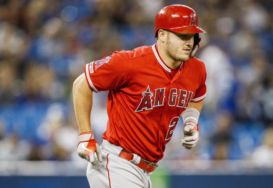 Los Angeles Angels' Mike Trout heads to first with a walk during the first inning of the team's baseball game against the Toronto Blue Jays on Thursday, June 20, 2019, in Toronto. (Mark Blinch/The Canadian Press via AP)