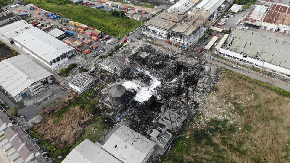 In this drone aerial photo provided by the Disaster Response Associations Thailand, twisted metal frames are all that remains of a burnt chemical factory Tuesday, July 6, 2021, in Samut Prakan, Thailand. Firefighters finally extinguished a blaze at a chemical factory just outside the Thai capital early Tuesday, more than 24-hours after it started with an explosion that damaged nearby homes and then let off a clouds of toxic smoke that prompted a widespread evacuation. (Disaster Response Associations Thailand via AP)