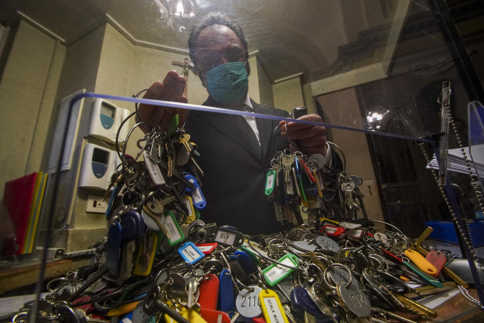 Gianni Crea, the Vatican Museums chief "Clavigero" key-keeper, sorts out keys as he prepares to open the museum, at the Vatican, Monday, Feb. 1, 2021. Crea is the “clavigero” of the Vatican Museums, the chief key-keeper whose job begins each morning at 5 a.m., opening the doors and turning on the lights through 7 kilometers of one of the world's greatest collections of art and antiquities. The Associated Press followed Crea on his rounds the first day the museum reopened to the public, joining him in the underground “bunker” where the 2,797 keys to the Vatican treasures are kept in wall safes overnight. (AP Photo/Andrew Medichini)