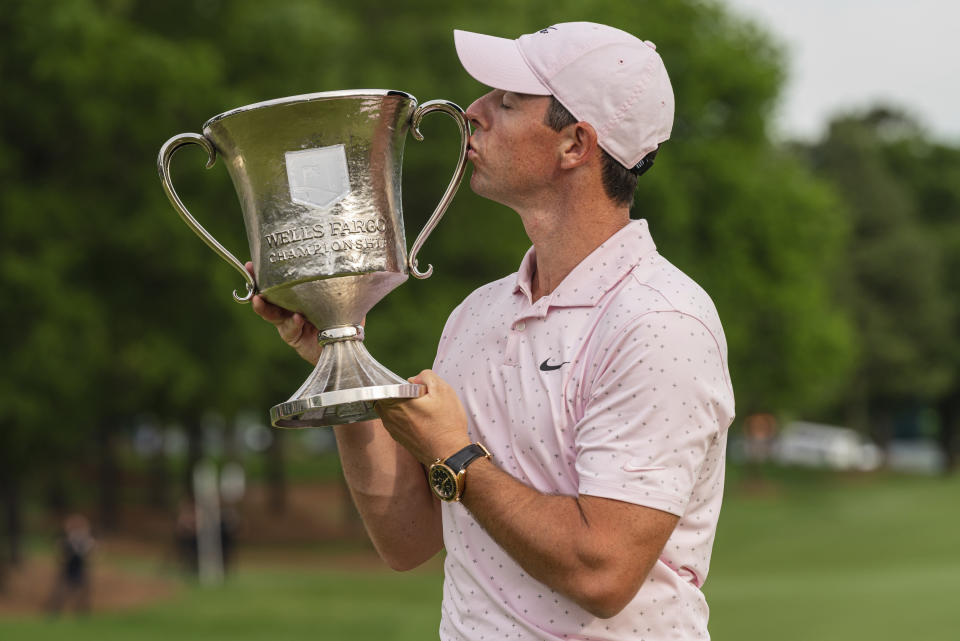 Rory McIlroy kisses the trophy after winning the Wells Fargo Championship golf tournament at Quail Hollow on Sunday, May 9, 2021, in Charlotte, N.C. (AP Photo/Jacob Kupferman)