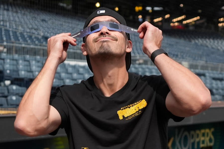 Pittsburgh Pirates’ Bryan Reynolds views the solar eclipse before a baseball game against the Detroit Tigers in Pittsburgh, Monday, April 8, 2024. (AP Photo/Gene J. Puskar)