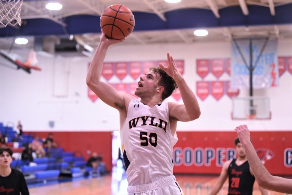 Wylie's Avery Brekke (50) lays the ball up during Friday's Key City Classic game against Borger at Cooper's Cougar Gym on Dec. 3, 2021. The Bulldogs won 56-46 to go 2-0 on the day.