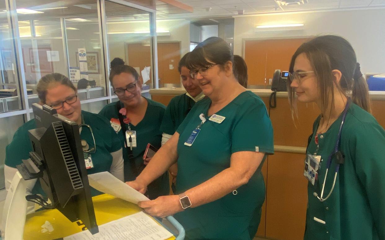 Daytona State College second-year associate in nursing students Ashley Boisvert, Tamera Encarnacion, Sherry Jarrell and Tori Anthony flank registered nurse and instructor Jenna Singleton on a clinical rotation at Halifax Health Medical Center on Thursday, April 20, 2023. Halifax Health donated $1 million to the college, helping the school raise $3.8 million for an effort to improve student-success rates and other upgrades to the nursing program.