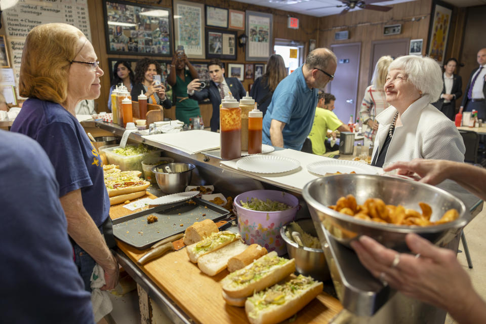 Secretary of the Treasury Janet Yellen, right, stands at the counter at Domilise's Po-Boy & Bar as a shrimp po-boy is made for her on Friday, June 30, 2023 in New Orleans. Yellen talked about how the Inflation Reduction Act is helping drive a manufacturing boom and helping lower costs for consumers. (Chris Granger/The Times-Picayune/The New Orleans Advocate via AP)