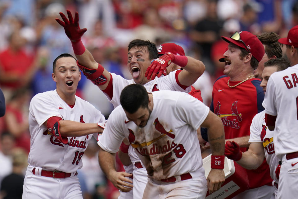 St. Louis Cardinals' Lars Nootbaar is congratulated by teammates Tommy Edman (19), Nolan Arenado (28) and Miles Mikolas, right, after hitting a walk-off single to score Arenado during the ninth inning in the first game of a baseball doubleheader against the Chicago Cubs Thursday, Aug. 4, 2022, in St. Louis. (AP Photo/Jeff Roberson)