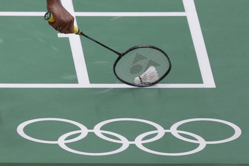 India's Srikanth Kidambi picks up the shuttlecock during a Men single match against Denmark's.