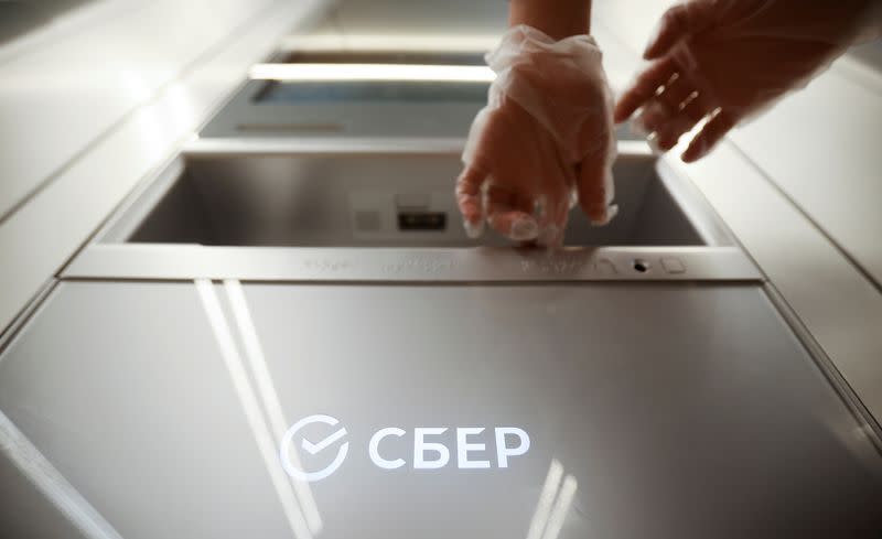 A woman uses an ATM machine in an office of the Russian largest lender Sberbank in Moscow