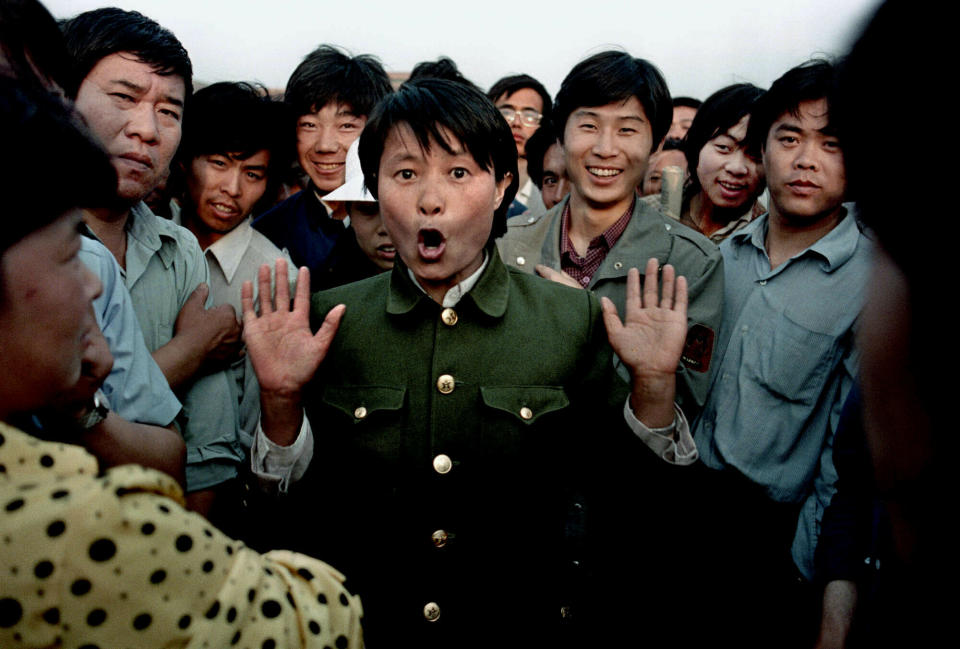 FILE - In this June 2, 1989 file photo, a woman soldier sings among pro-democracy protesters occupying Beijing's Tiananmen Square. Police and military would occasionally mix with protesters in an attempt to keep the demonstration peaceful. Over seven weeks in 1989, the student-led pro-democracy protests centered on Beijing’s Tiananmen Square became China’s greatest political upheaval since the end of the decade-long Cultural Revolution more than a decade earlier.(AP Photo/Jeff Widener, File)