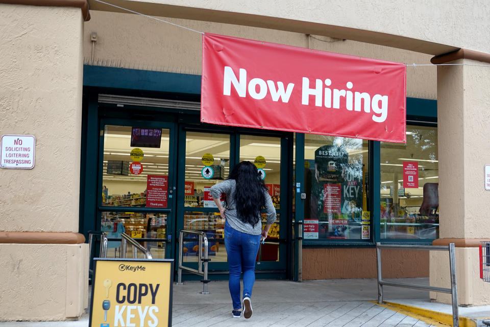 HALLANDALE, FLORIDA - SEPTEMBER 21: A Now Hiring sign hangs near the entrance to a Winn-Dixie Supermarket on September 21, 2021 in Hallandale, Florida. Government reports indicate that Initial jobless benefit claims rose 20,000 to 332,000 in the week ended Sept. 11. (Photo by Joe Raedle/Getty Images)