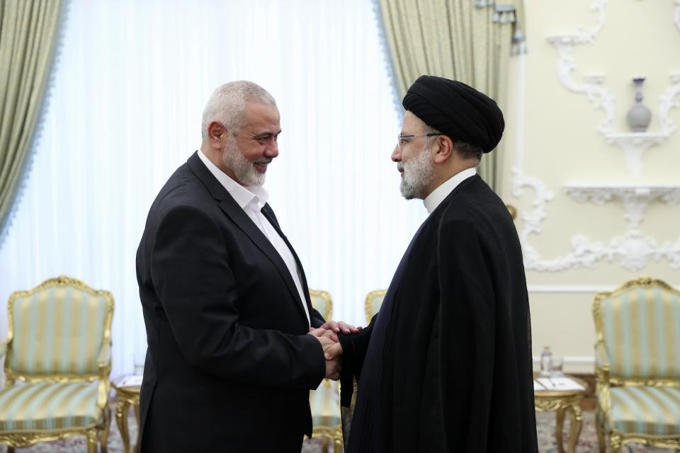 FILE - In this photo released by the Iranian Presidency Office, President Ebrahim Raisi, right, greets the leader of the Palestinian militant group Hamas, Ismail Haniyeh at the start of their meeting at his office in Tehran, Iran, on June 20, 2023. Several Hamas leaders have visited Russia, which has sought to maintain contacts with the group. (Iranian Presidency Office via AP, File)