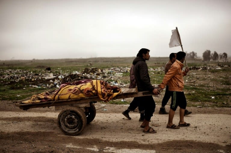 Relatives transport the bodies of west Mosul residents allegedly killed in an airstrike targeting Islamic State group jihadists on March 17, 2017