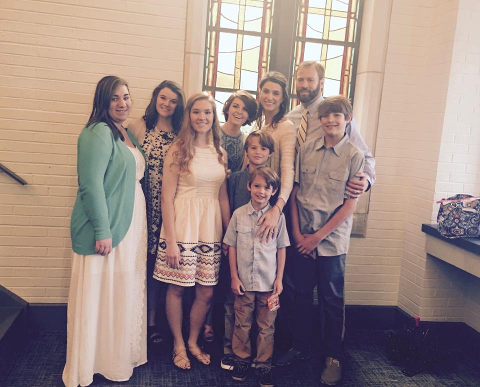 The Phillips family opened their home and lives to four girls in 2016. Cade Phillips is on the right with his father, John David, and mother, Reagan, behind him. His younger brothers, Will and Gibbs are in front.