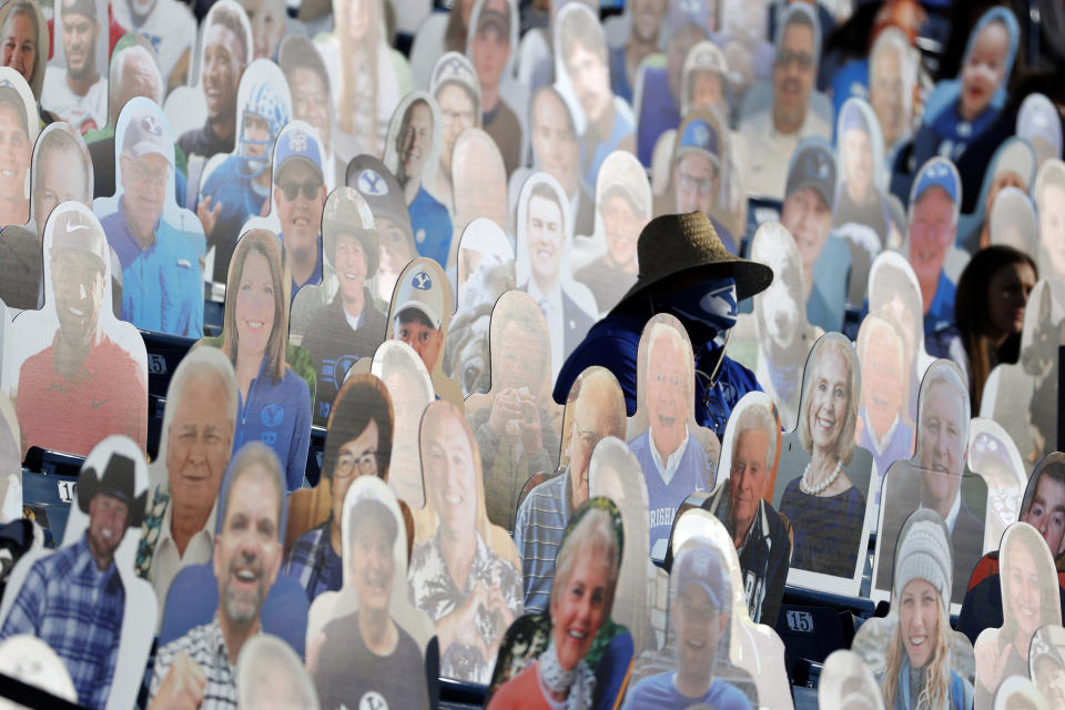 A BYU fans sits among the cardboard fan cutouts during an NCAA college football game against North Alabama, Saturday, Nov. 21, 2020, in Provo, Utah. (AP Photo/Jeff Swinger, Pool)