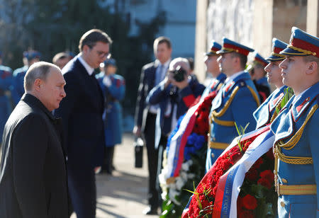 Russian President Vladimir Putin stands next to Serbian President Aleksandar Vucic as they lay wreath at Cemetery of Liberators of Belgrade, in Belgrade, Serbia, January 17, 2019. REUTERS/Goran Tomasevic