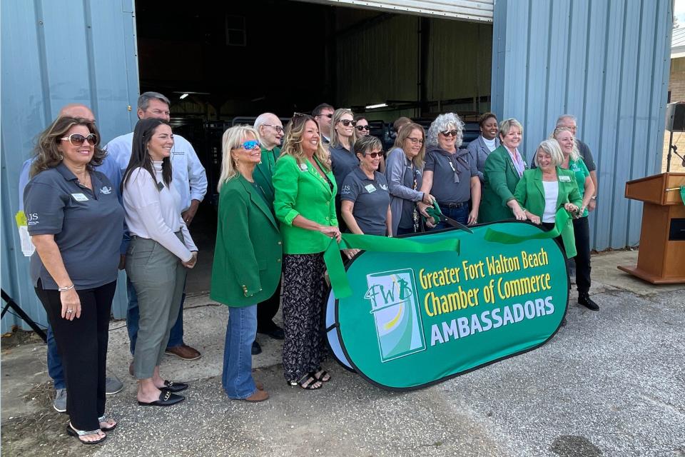 One Hopeful Place board members and Greater Fort Walton Beach Chamber of Commerce ambassadors cut a ceremonial ribbon during the unveiling of One Hopeful Place's new 48-bed cold-night shelter on Wednesday.