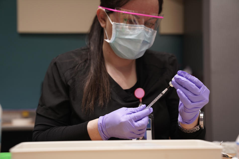 A pharmacist prepares a syringe of the Pfizer BioNtech Covid-19 vaccine in Arizona.