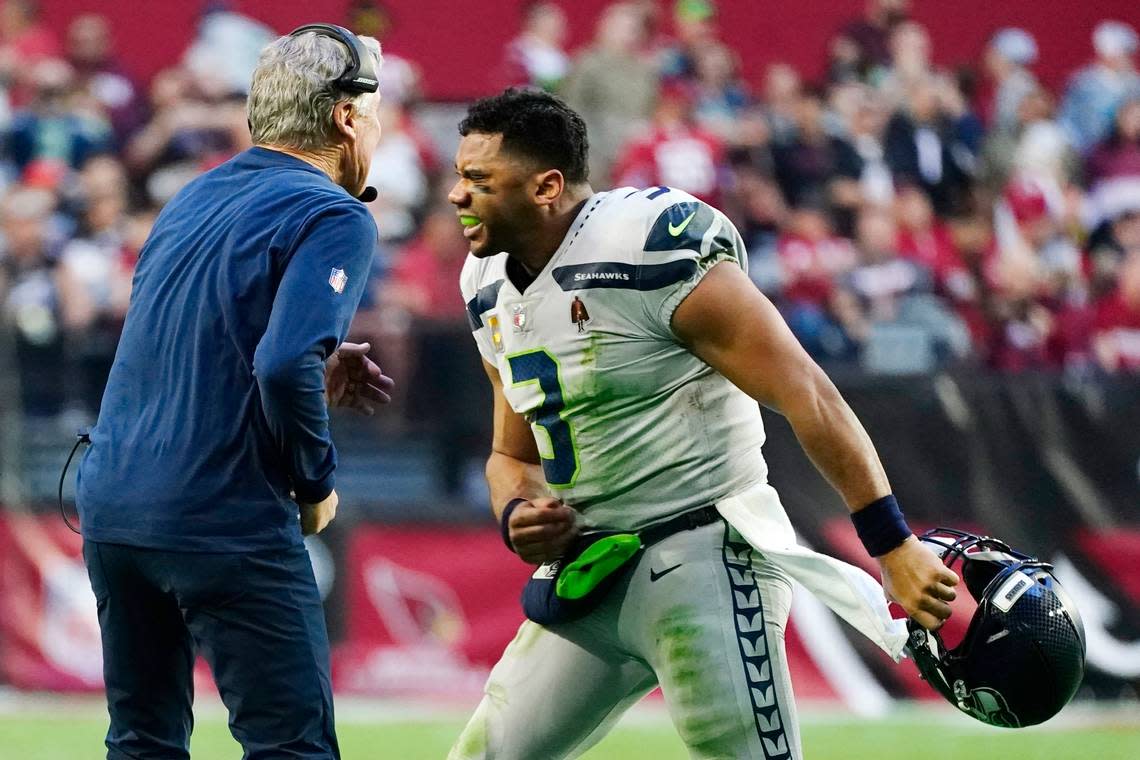 Seattle Seahawks quarterback Russell Wilson (3) celebrates a touchdown against the Arizona Cardinals with Seahawks head coach Pete Carroll, left, during the second half of an NFL football game Sunday, Jan. 9, 2022, in Glendale, Ariz. (AP Photo/Ralph Freso)