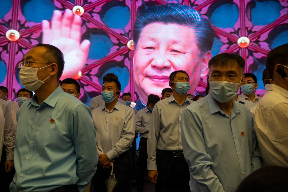 Visitors stand inside the Memorial of the FirstNational Congress of the Communist Party of China, as Xi is seen on the screen in the back, on June 17, 2021 in Shanghai, China.<span class="copyright">Andrea Verdelli—Getty Images</span>