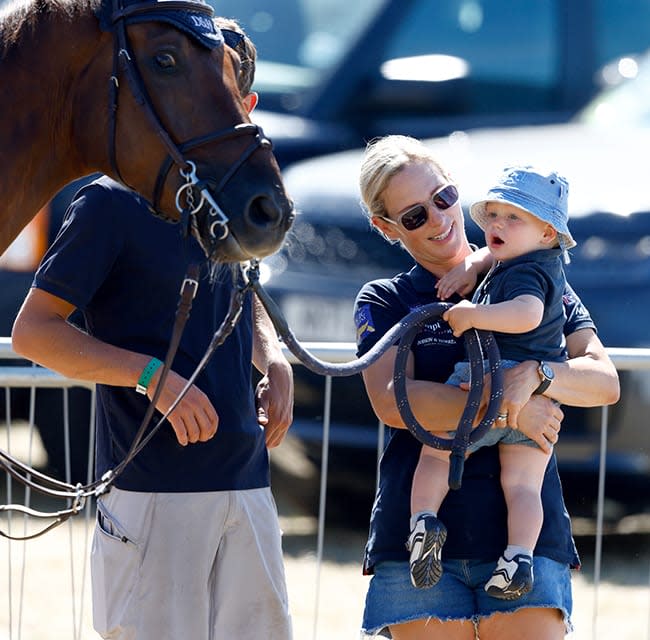 Zara Tindall holds son Lucas as he watches a horse