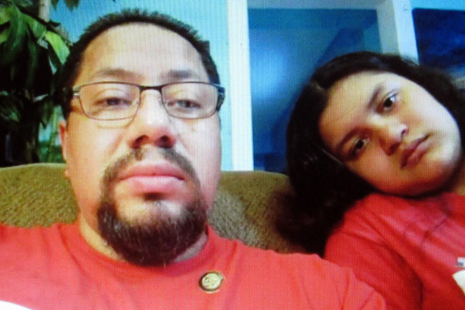 Mario Guzman, left, a server at a restaurant in the Borgata casino in Atlantic City N.J. discusses the continuing unemployment of many casino workers during an online meeting from his home with his daughter Kimberly, right, Wednesday, July 8, 2020. Many Atlantic City casino workers were ready to return to work on July 2 until Gov. Phil Murphy banned indoor dining due to the virus outbreak, preventing casinos from opening their restaurants and canceling plans to bring these workers back. (AP Photo/Wayne Parry)