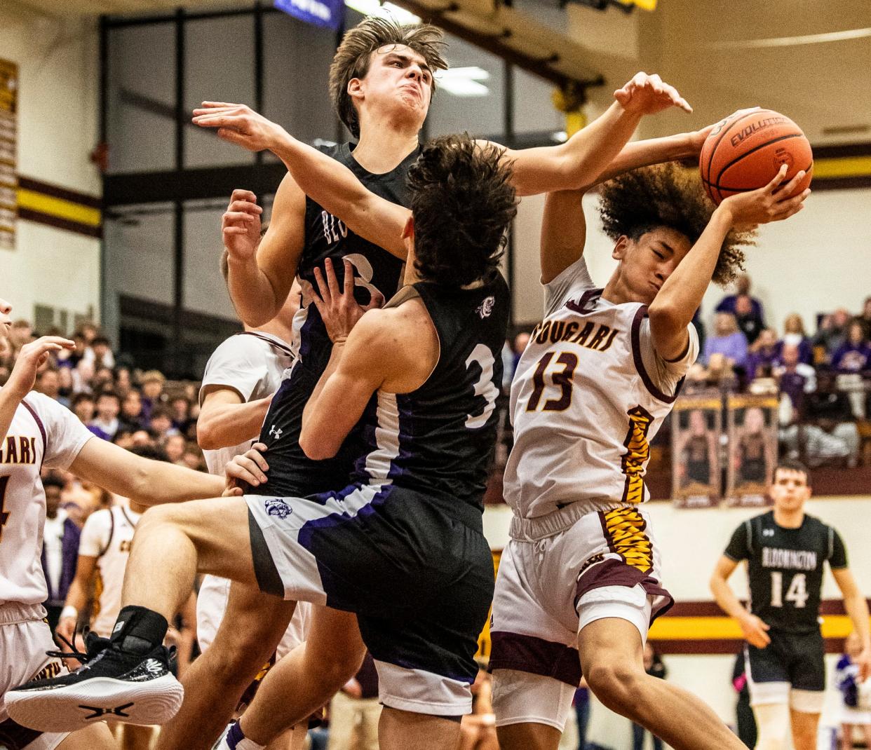 North's Derrick Cross Jr. (14) grabs a rebound during the Bloomington North versus Bloomington South boys basketball game at Bloomington High School North on Friday, Jan. 5, 2024. North won the game 56-53.