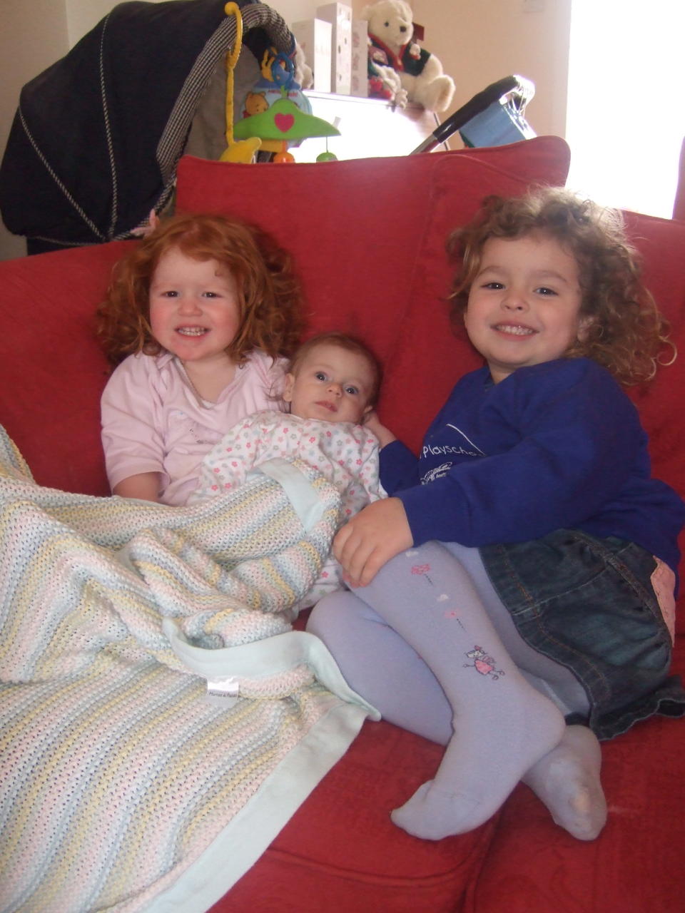 Adoring sisters Katie 3, Rosie 2, with Lilly at 8 months (Supplied)
