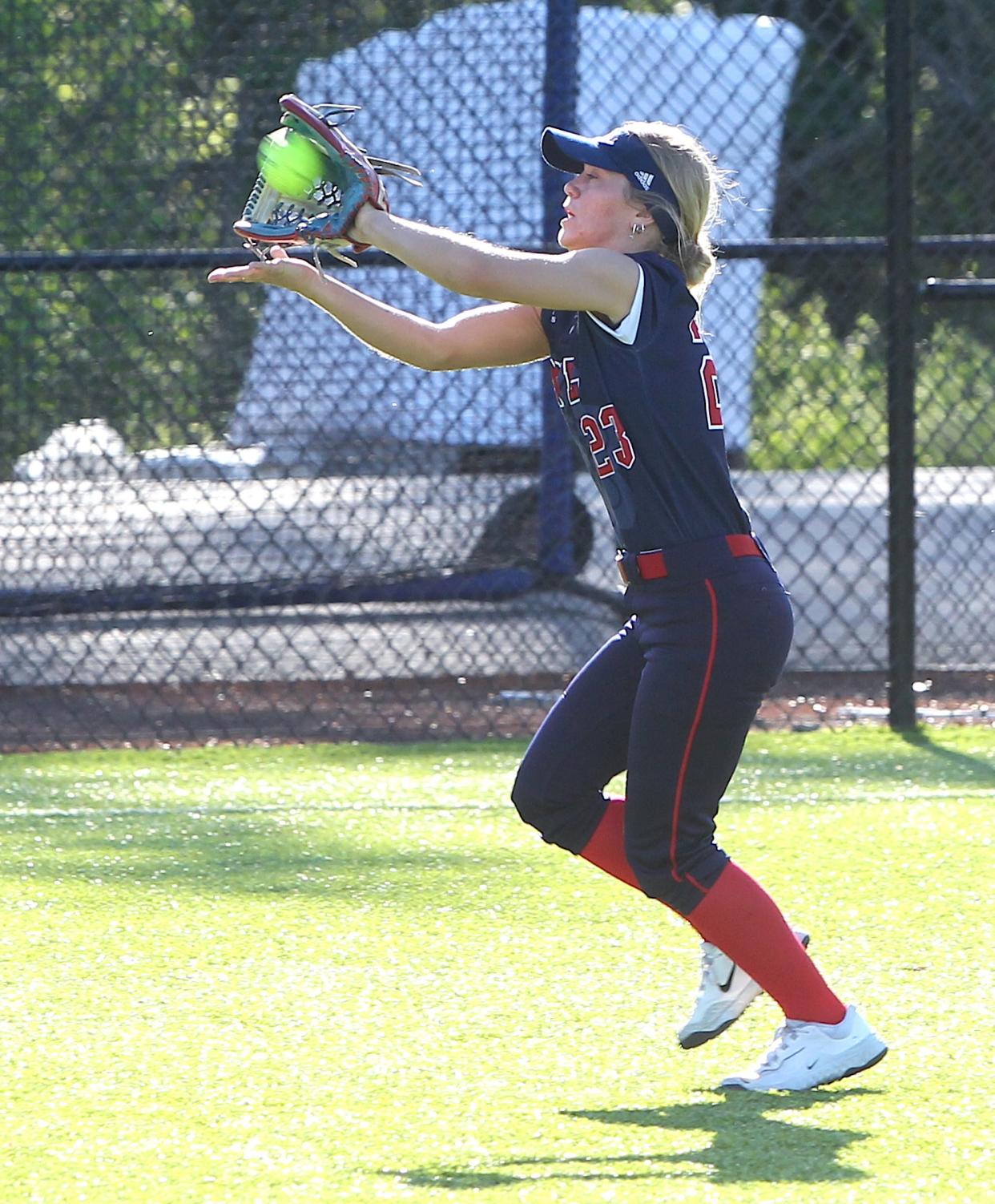 Bedford North Lawrence's Britta Warren (23) snags a long ball back by the warning track on Monday, April 29, 2024.