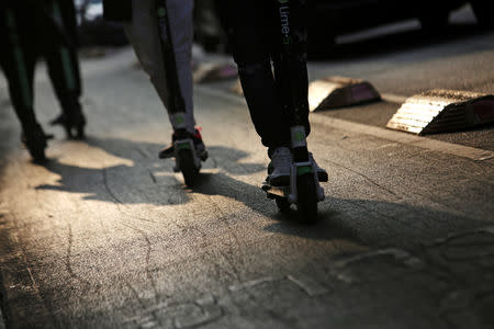 People use electric scooters in a neighbourhood in Mexico City, Mexico January 10, 2019. REUTERS/Daniel Becerril