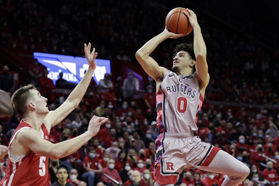 Rutgers guard Geo Baker (0) shoots over Wisconsin forward Tyler Wahl during the second half of an NCAA college basketball game Saturday, Feb. 26, 2022, in Piscataway, N.J. (AP Photo/Adam Hunger)