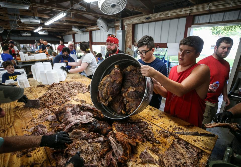 Barbecue is piled on the cutting table at the Fancy Farm picnic in August 2021. The event, known for its food and political speeches, is a fundraiser for St. Jerome's Catholic Church in the town of Fancy Farm in Western Kentucky.