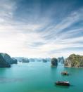 <p>Boats weave between rock formations in Halong Bay, Vietnam.</p>