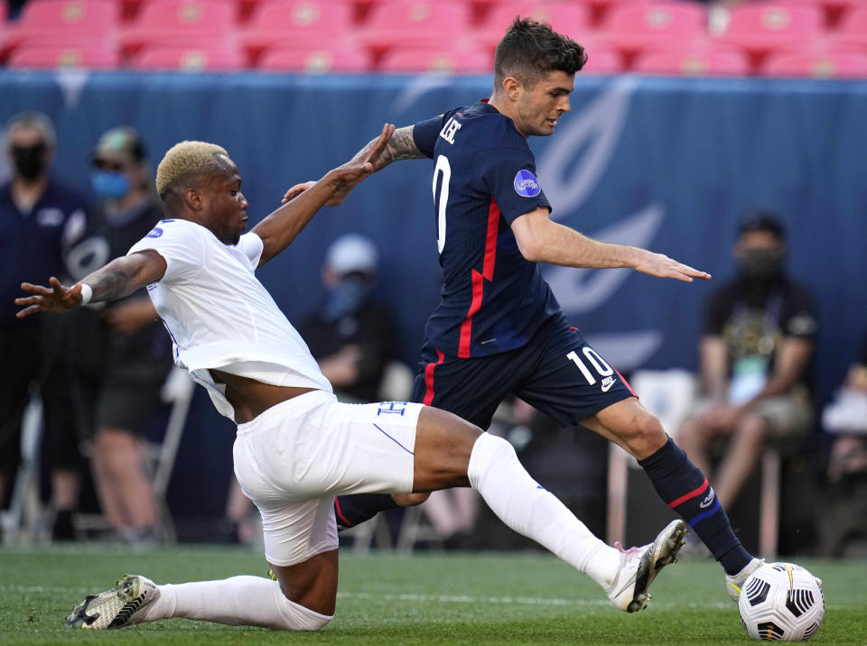 United States' Christian Pulisic (10) moves the ball as Honduras' Kevin Álvarez defends during the first half of a CONCACAF Nations League soccer semifinal Thursday, June 3, 2021, in Denver. (AP Photo/Jack Dempsey)