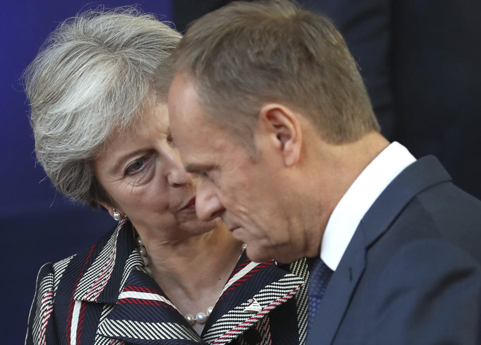 British Prime Minister Theresa May, left, speaks with European Council President Donald Tusk after a group photo during an EU-ASEM summit in Brussels, Friday, Oct. 19, 2018. EU leaders met with their Asian counterparts Friday to discuss trade, among other issues. (AP Photo/Francisco Seco)