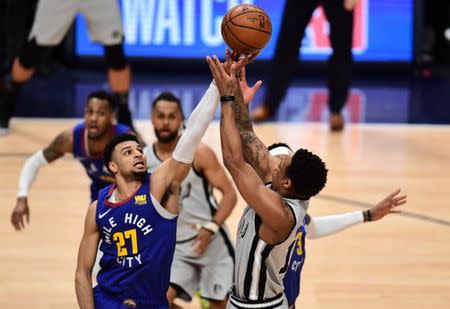 Apr 13, 2019; Denver, CO, USA; San Antonio Spurs guard DeMar DeRozan (10) shoots over Denver Nuggets guard Jamal Murray (27) in the second half in the second quarter in the first round of the 2019 NBA Playoffs at the Pepsi Center. Mandatory Credit: Ron Chenoy-USA TODAY Sports