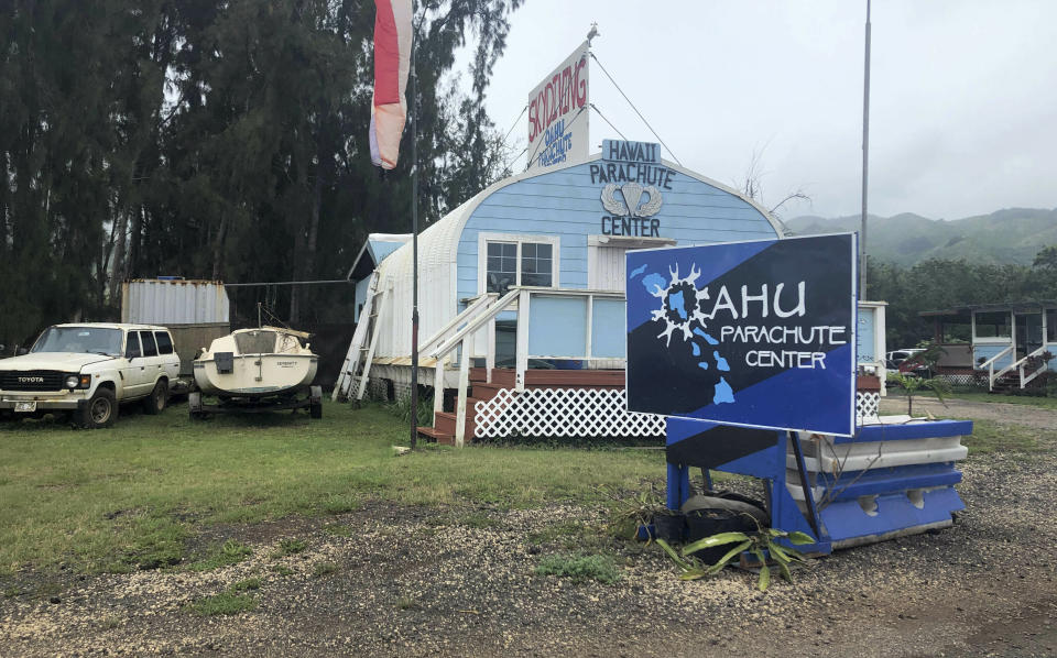 FILE - In this Friday, June 28, 2019 file photo, the Oahu Parachute Center is shown near Dillingham Airfield in Waialua, Hawaii. The skydiving company was operating a plane on June 21, 2019 that crashed near the airport. The National Transportation Safety Board says a witness to the crash that killed 11 people reported the plane's engines sounded normal before takeoff, but shortly after the plane left the ground it became inverted and crashed nose down. The NTSB's preliminary report was released Tuesday, July 9, 2019. No cause for the crash was given, which is typical for preliminary reports. (AP Photo/Caleb Jones, File)