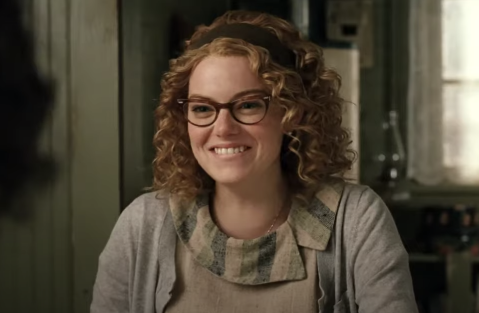 Emma Stone with a short, curly wig