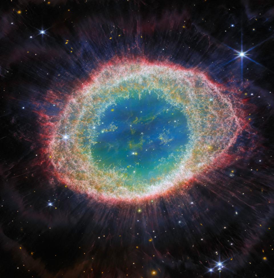A dying star, with a red, shimmering outer ridge and different colors in different areas of the interior