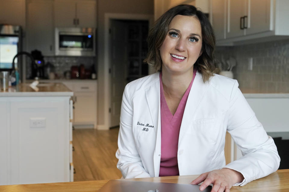 Dr. Michelle Rockwell, who was targeted by vaccine opponents after she posted about her miscarriage online, speaks during an interview at her home Wednesday, April 28, 2021, in Jenks, Okla. Individuals across the country, like Rockwell, have found themselves swept into the misinformation maelstrom, their online posts or their very identities hijacked by anti-vaccine activists and others peddling lies about the COVID-19 outbreak. (AP Photo/Sue Ogrocki)