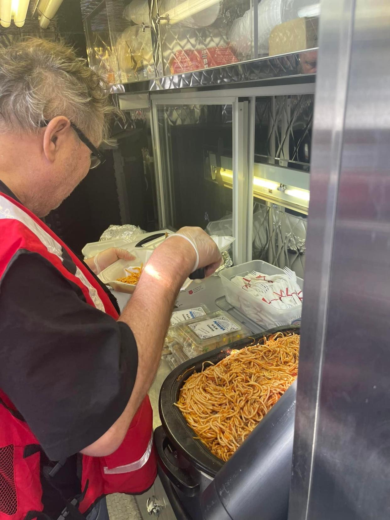 Salvation Army member Dennis Benthin helps prepare meals for the free dinner program.