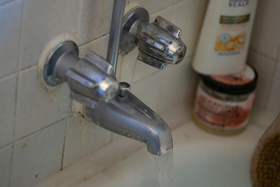 Muriah Govan says leaky faucets are one of many maintenance issues in her unit that managers at Willow Brook Apartments have not resolved, seen Thursday, July 13, 2023, in Indianapolis. Govan said the faucet issue keeps her from attaching a shower head that she needs in order to care for her ailing live-in parents. 