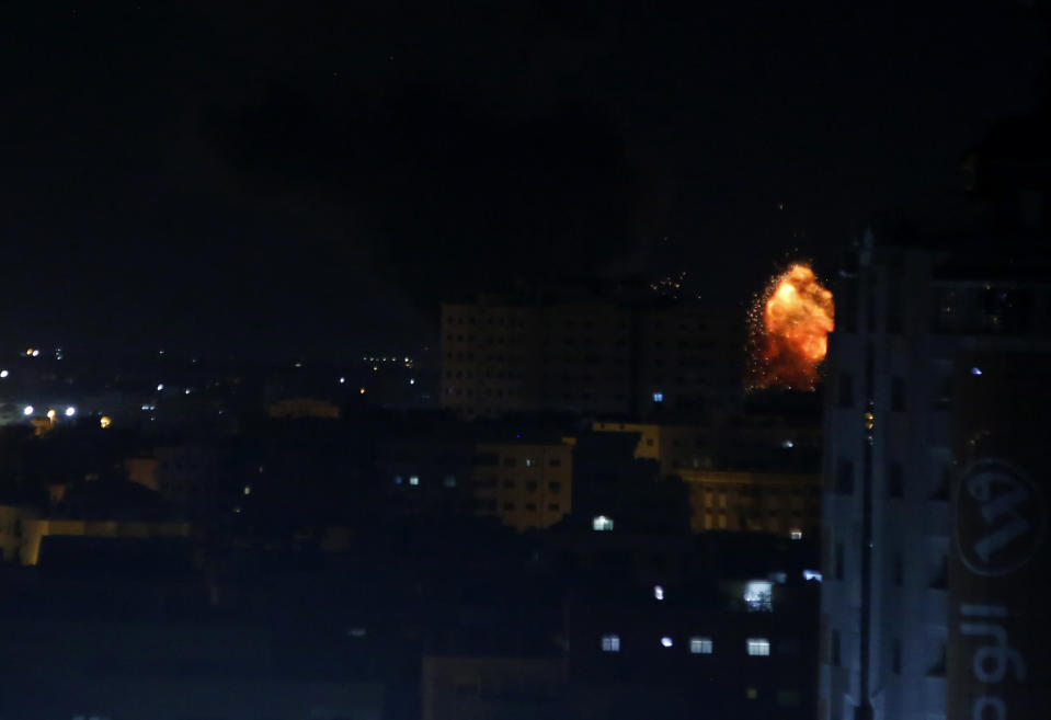 An explosion caused by Israeli airstrikes is seen on Gaza City, early Saturday, Oct. 27, 2018. Israeli aircraft struck several militant sites across the Gaza Strip early Saturday shortly after militants fired rockets into southern Israel, the Israeli military said. (AP Photo/Adel Hana)