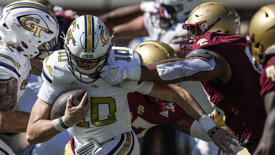 Boston College defensive tackle Nigel Tate (98) grabs the mask of Georgia Tech quarterback Haynes King (10) during the first half of an NCAA college football game, Saturday, Oct. 21, 2023, in Atlanta. Tate was charged with a penalty on the play. (AP Photo/Mike Stewart)