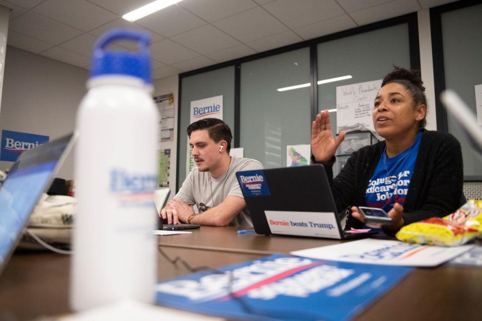 Volunteer Ben Miles calls potential voters while Tianna Mills, a field organizer for the Bernie Sanders campaign, talks to another volunteer at the campaign office in Greenville, S.C., on Feb. 13.